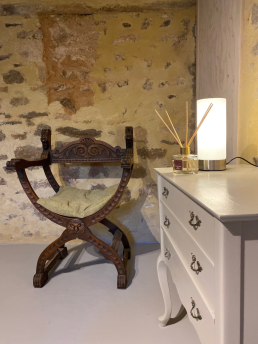 A cosy sit corner with antique wood carved chair and Queen Anne commode.