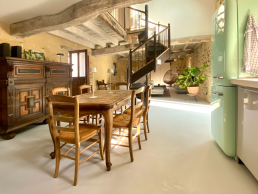 Inviting dining room with light oak old table and original Normandian chairs, antique cabinet and large Smeg refridgerator.e.