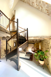 An antique spiral staircase leads to the first floor, from the dining room.