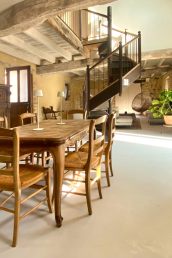 Inviting dining room with light oak old table and original Normandian chairs, antique cabinet and large Smeg refridgerator.e.